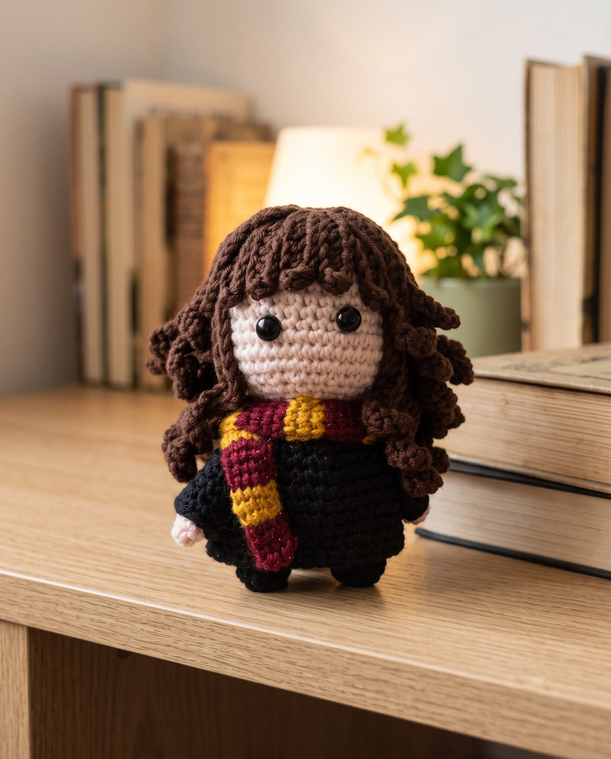 Hermione crochet toy sitting on a wooden shelf
